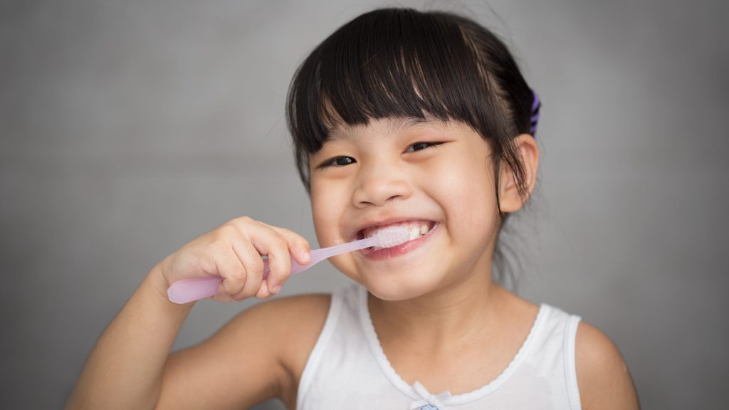 Pediatric dental patient brushing teeth at Washington MI family dentists